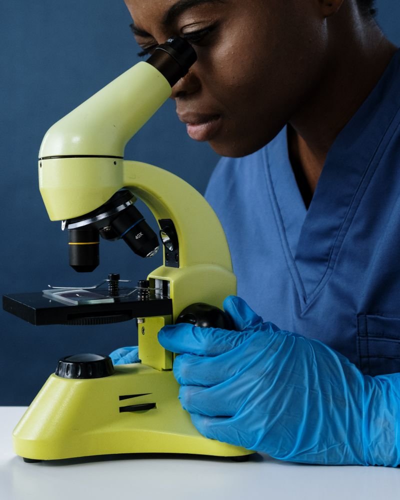 Laboratory scientist examining a sample under a microscope