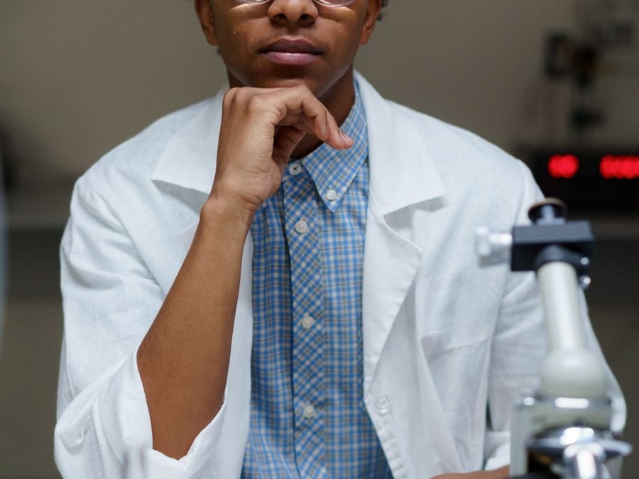 Laboratory scientist at a bench with a microscope